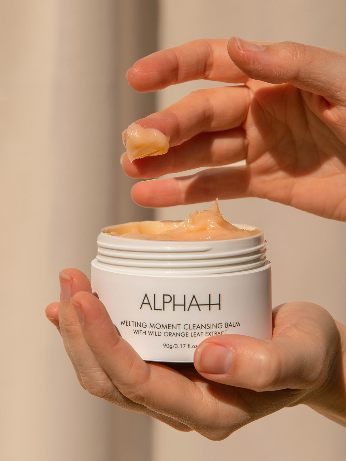 The Alpha-H Melting Moment Cleansing Balm is a buttery soft cleansing balm for all skin types designed to thoroughly remove stubborn makeup, SPF, dirt and pollution, while nourishing and softening the skin.
Enriched with Australian wild orange leaf, Grapeseed oil, Australian Sandalwood Seed Oil and Bisabolol (Chamomile) this delicious balm-to-oil cleanser expertly removes stubborn makeup, SPF and dirt while maintaining the skins delicate pH and skin barrier.